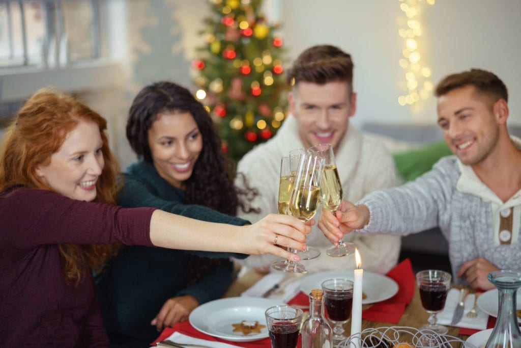 coworkers toasting champagne at office holiday party