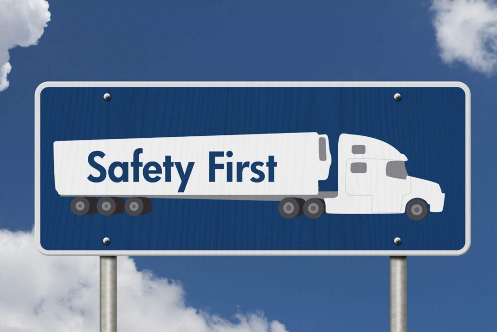 A billboard image of a truck that reads "Safety First"