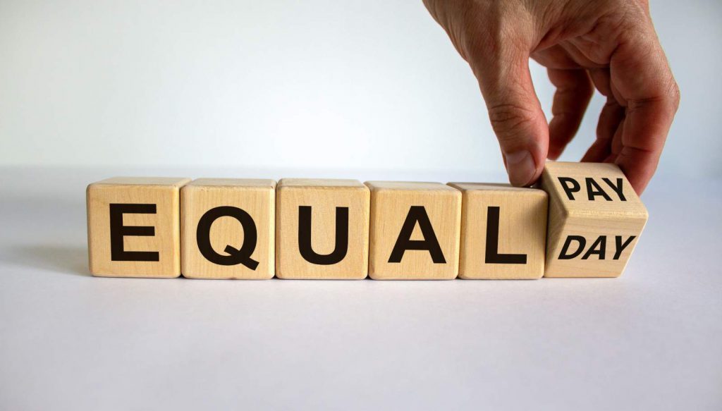 Blocks spelling out equality, representing equal pay
