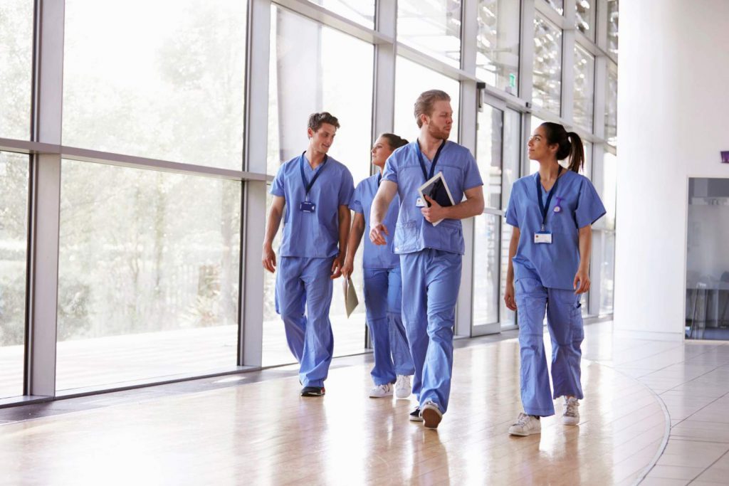 A group of nurses walking together in a hospital