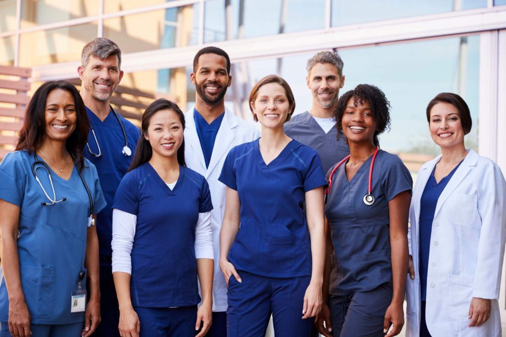 A group of nurses and medical professionals smiling at the camera
