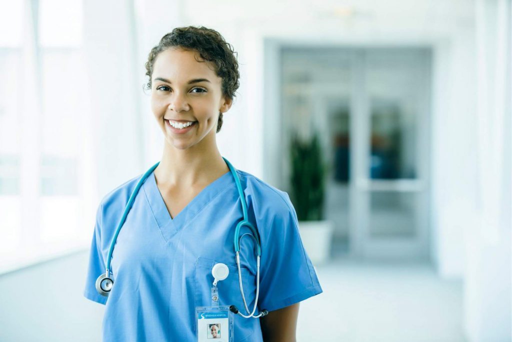 A female nurse smiling in a hospital