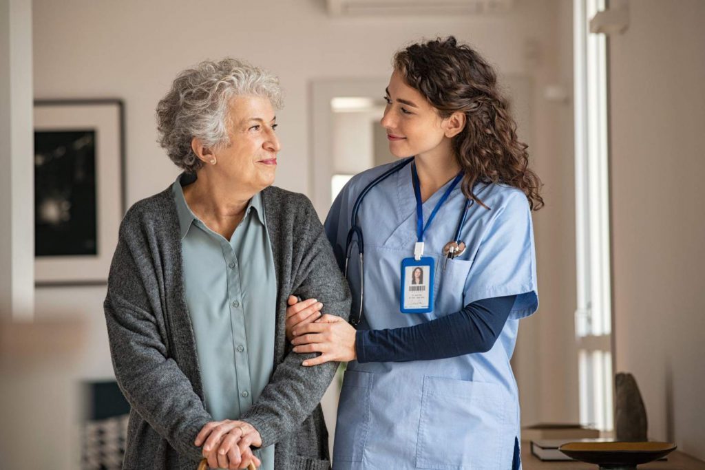 A young nurse caring for an elderly patient