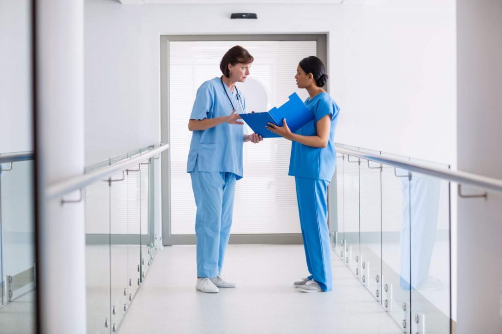 Two nurses consulting on a case together