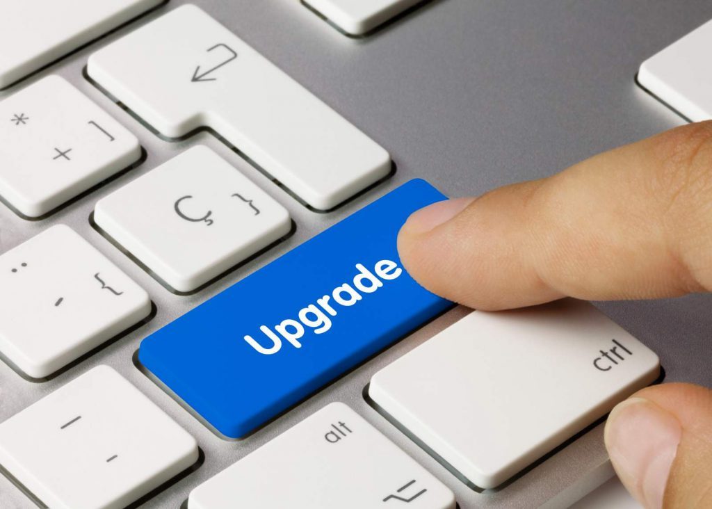 pressing the word upgrade on a computer keyboard