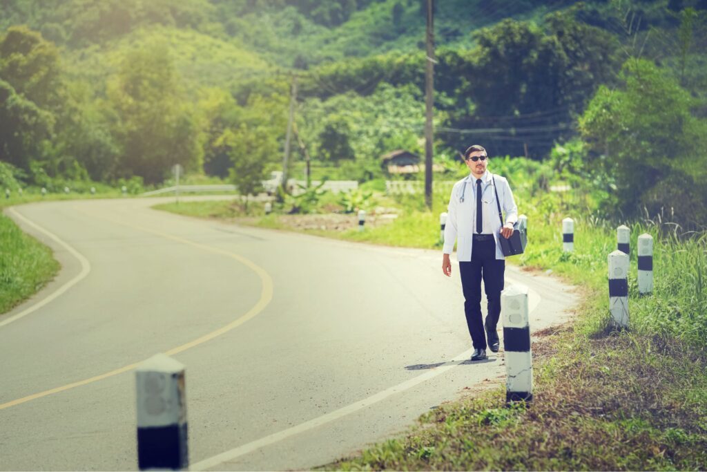 A doctor walking on the side of a rural road