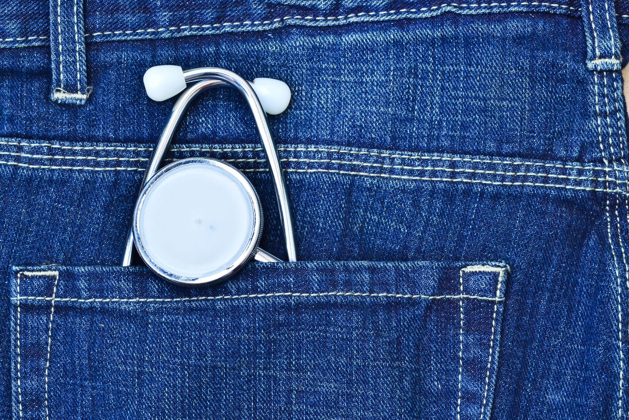 A stethoscope in the back pocket of a pair of blue jeans