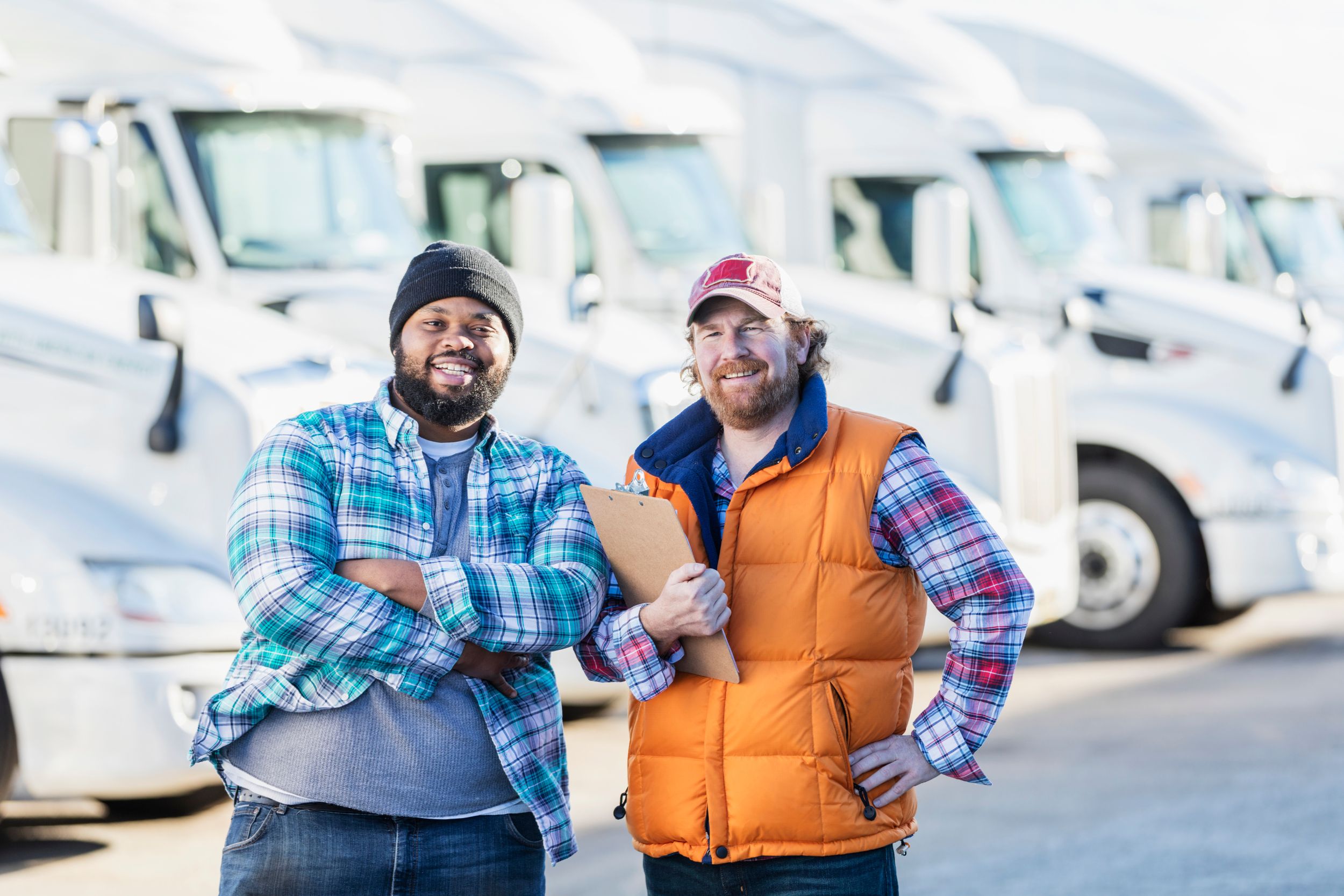Two truck drivers smiling at the camera