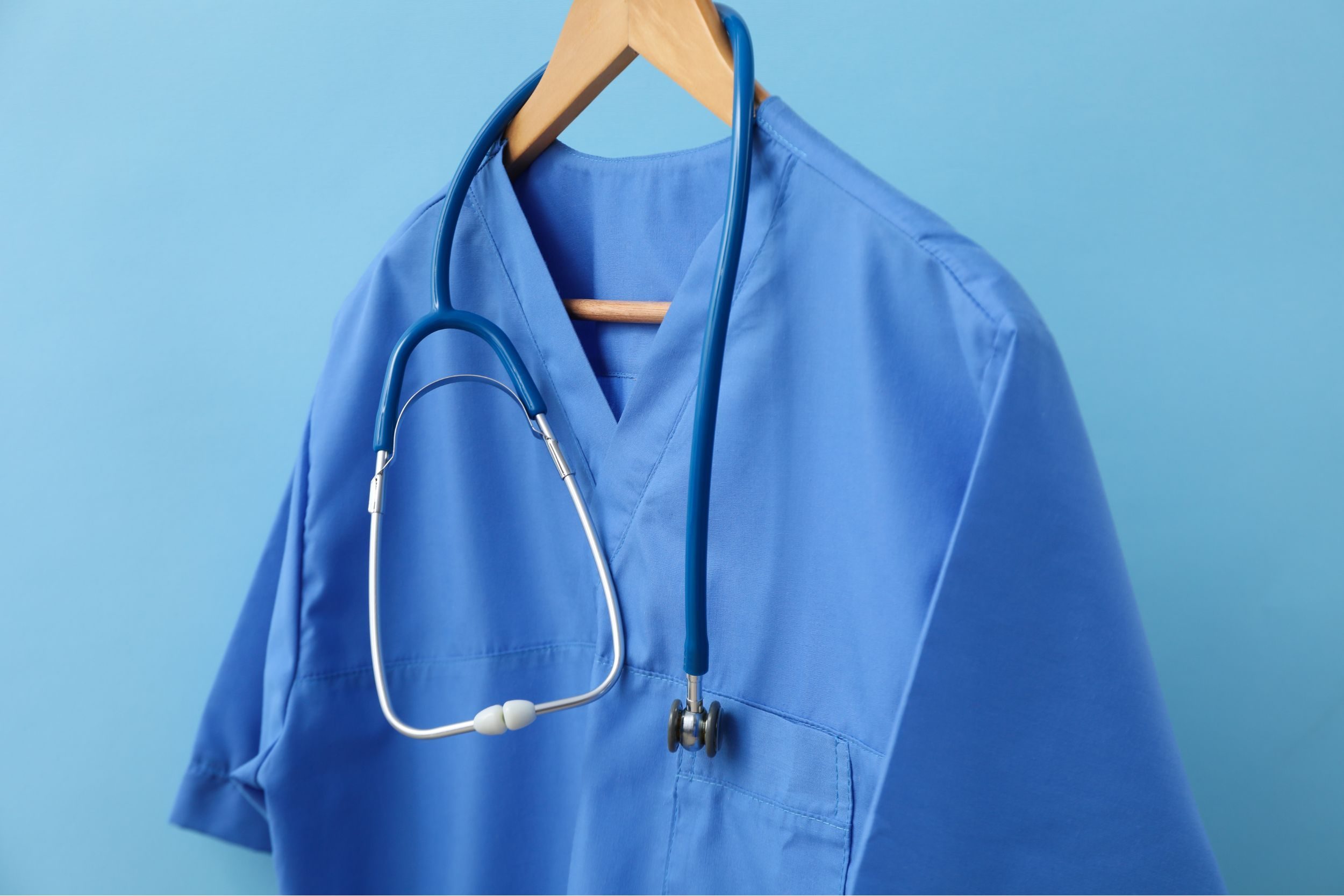 Scrubs and a stethoscope on a hanger