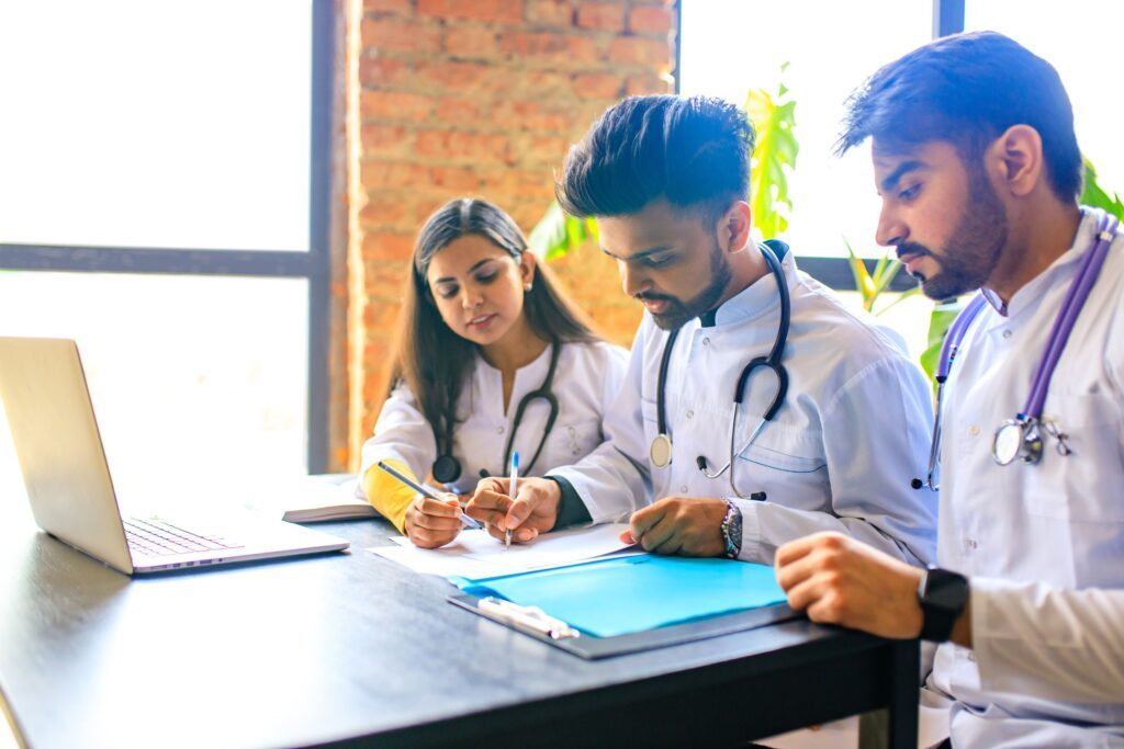 A group of three doctors studying together