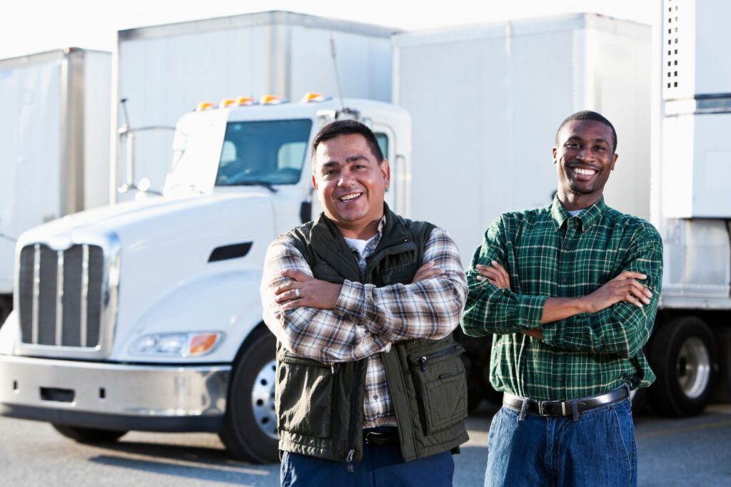 Two truck drivers smiling at the camera
