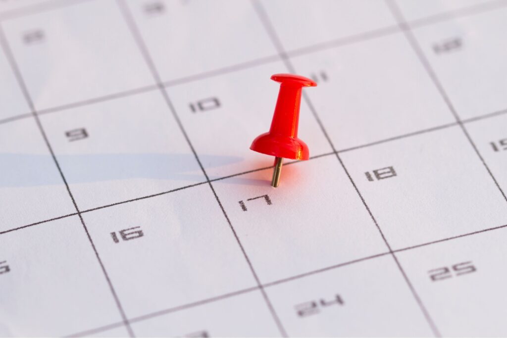 A thumbtack set on a date on the calendar