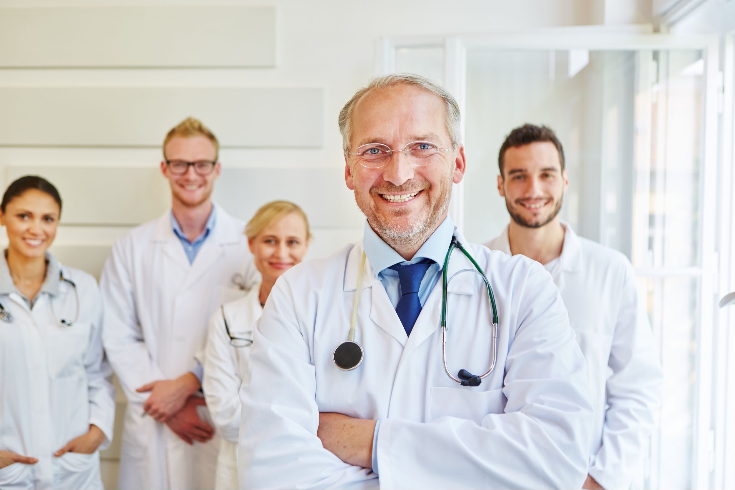 A group of physicians smiling at the camera