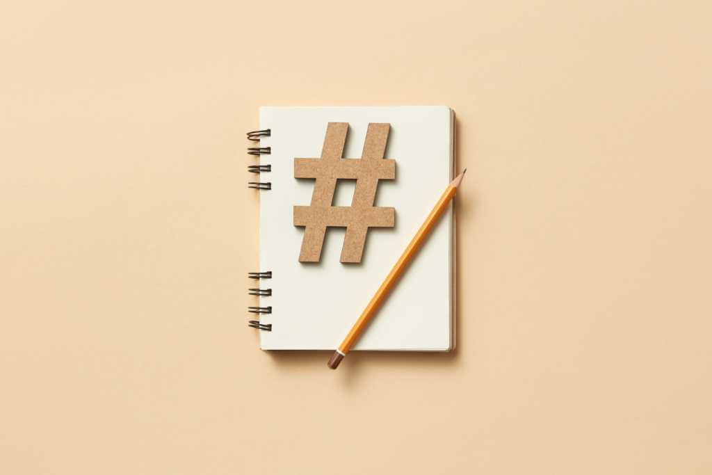 A hashtag symbol on a notebook with a pencil