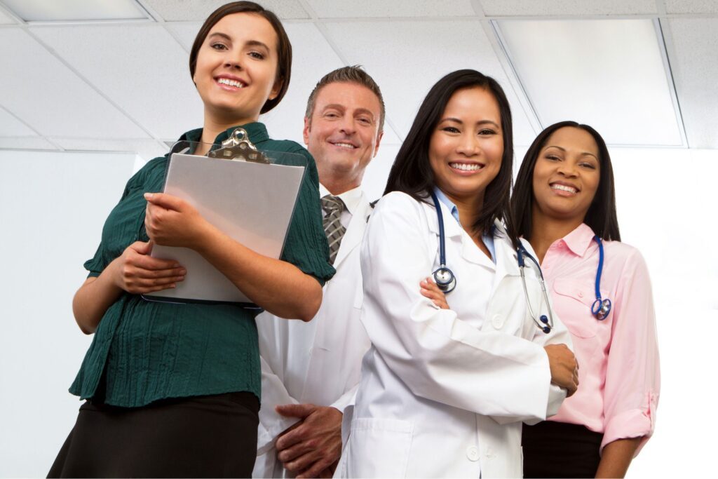 A group of diverse healthcare workers smiling at the camera