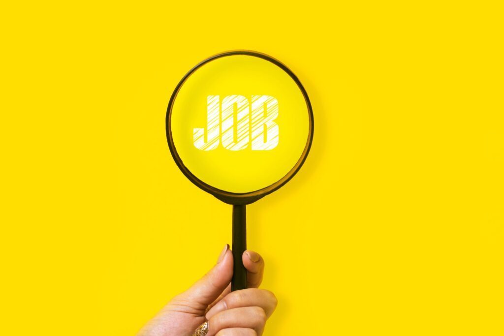 A magnifying glass highlighting the word "job" on a yellow background