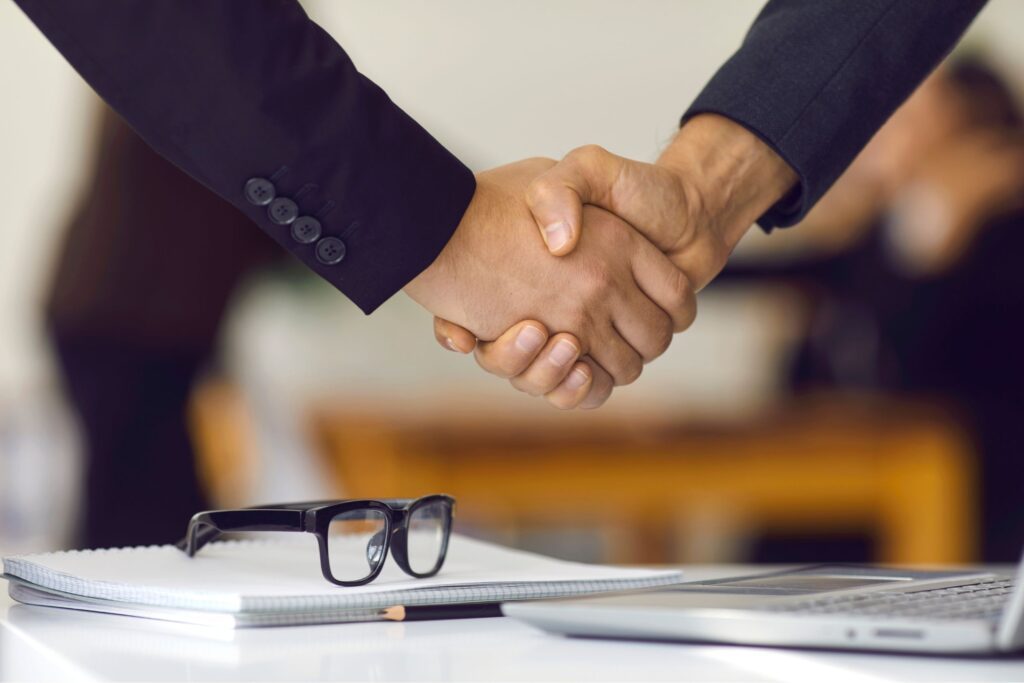 Two people shaking hands after a job interview